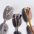 Assorted aviator sunglasses frames in silver, black, and gold with tinted lenses