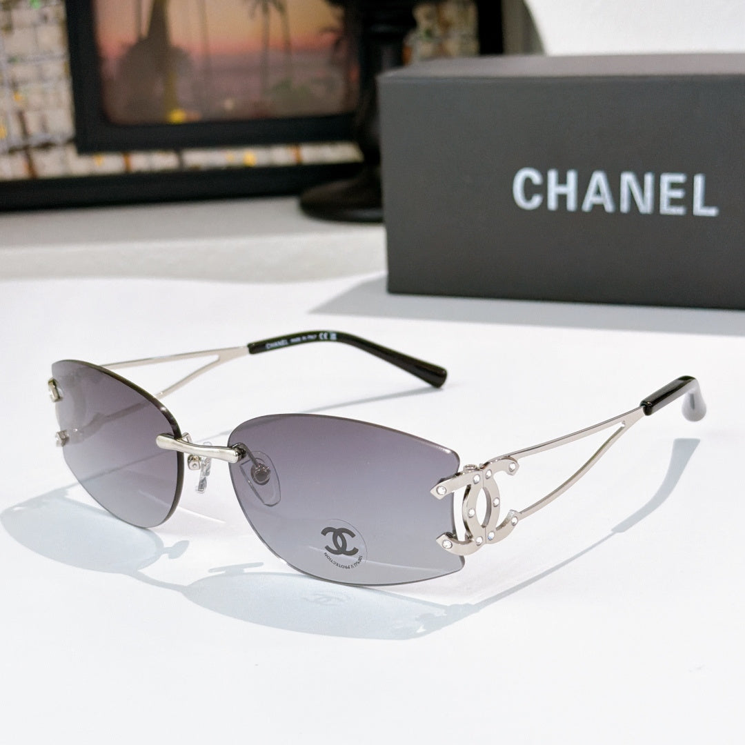 Silver-tone aviator sunglasses with dark gray lenses and Chanel emblem on the lens