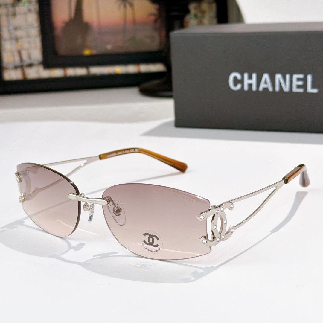 Gold-tone aviator sunglasses with light mauve lenses and Chanel logo on the lens