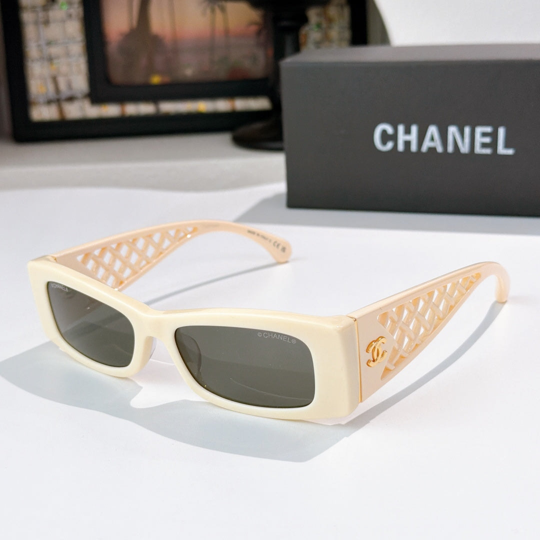 Chanel sunglasses, cream frames with dark lenses and gold-tone lattice temples