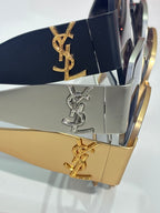 Sunglasses temples with YSL logo plaques in navy, silver, and gold