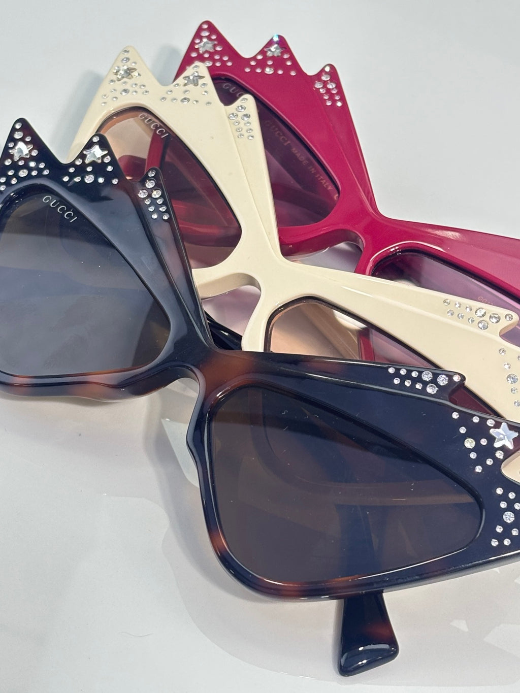 Cat-eye sunglasses in navy, cream, and burgundy with rhinestone-studded crowns