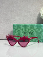 Burgundy cat-eye sunglasses with rhinestone-studded temples and tinted lenses, logo