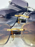 Cartier close-up: gold-tone bridge and metal temples on blue-tinted square lenses