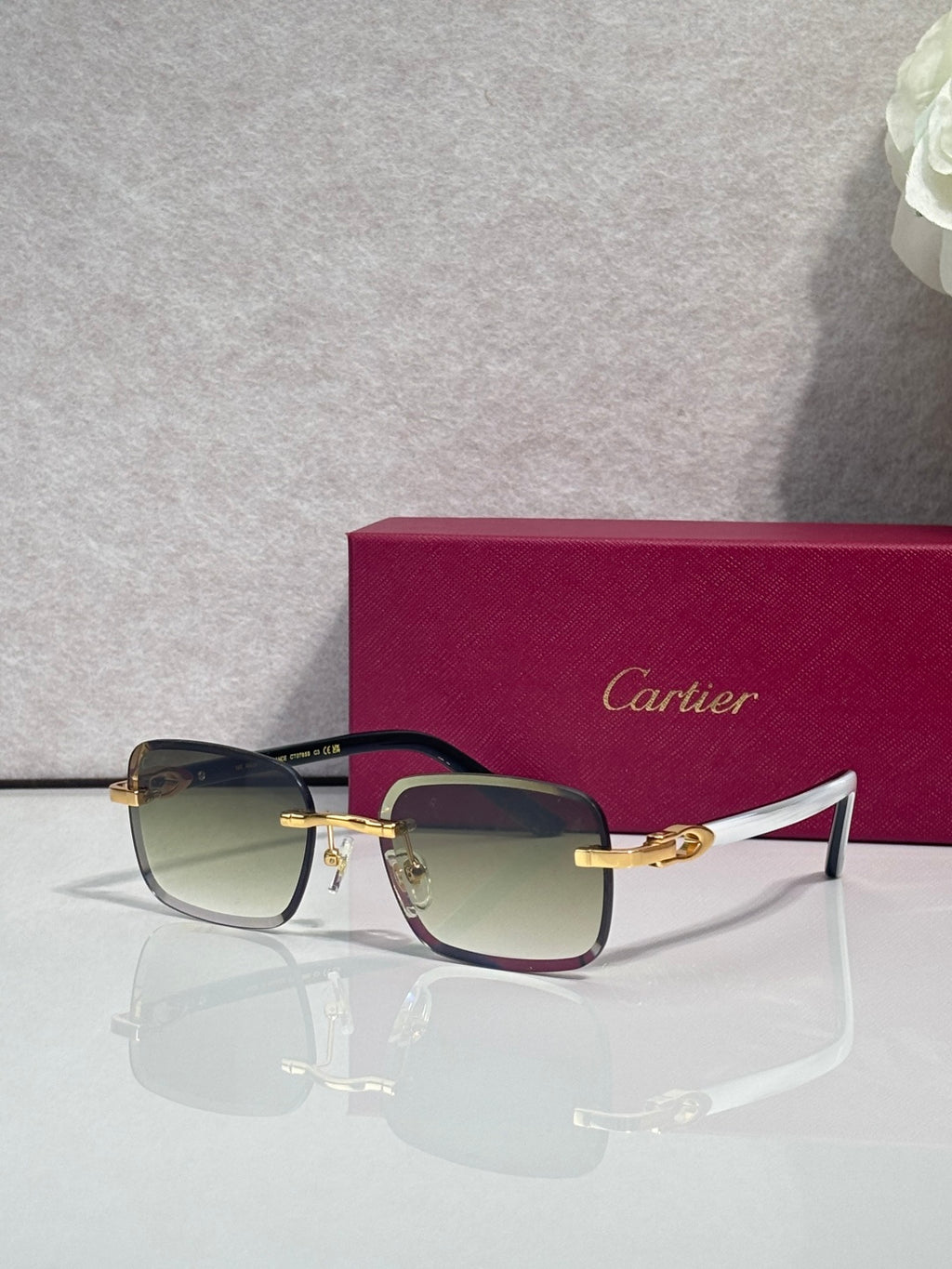 Cartier square glasses with dark frames, gold-tone temples, clear lenses with tint
