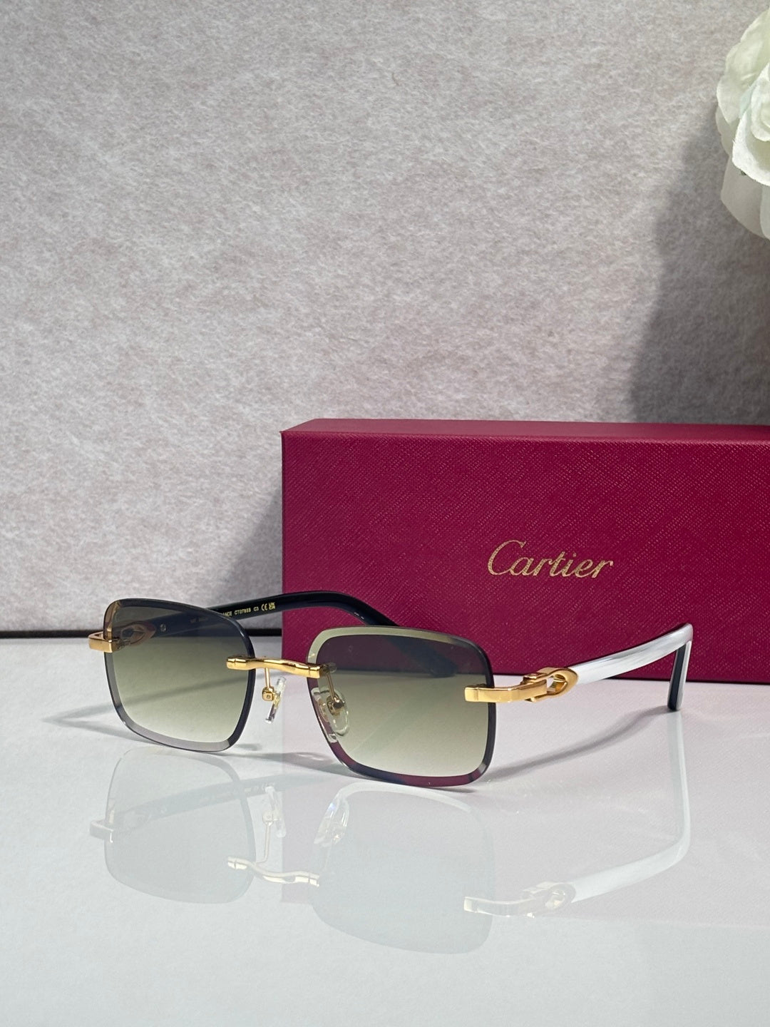 Cartier square glasses with dark frames, gold-tone temples, clear lenses with tint