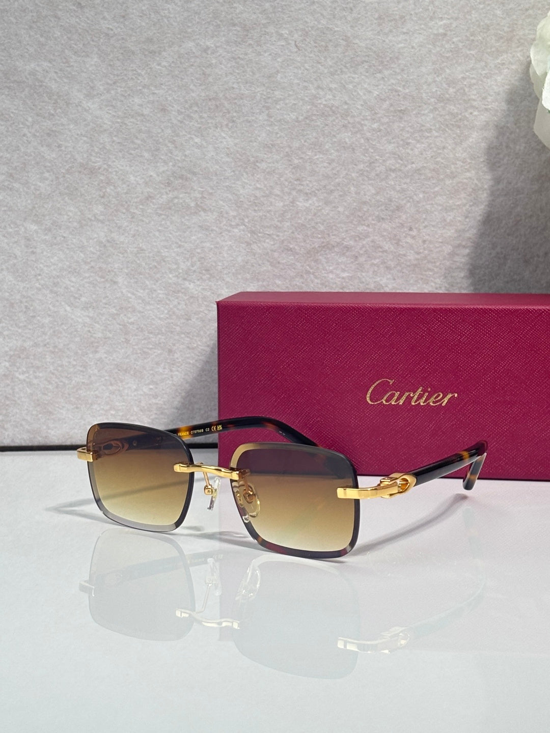 Cartier square glasses with dark frames, gold-tone hardware and temples, tinted lenses