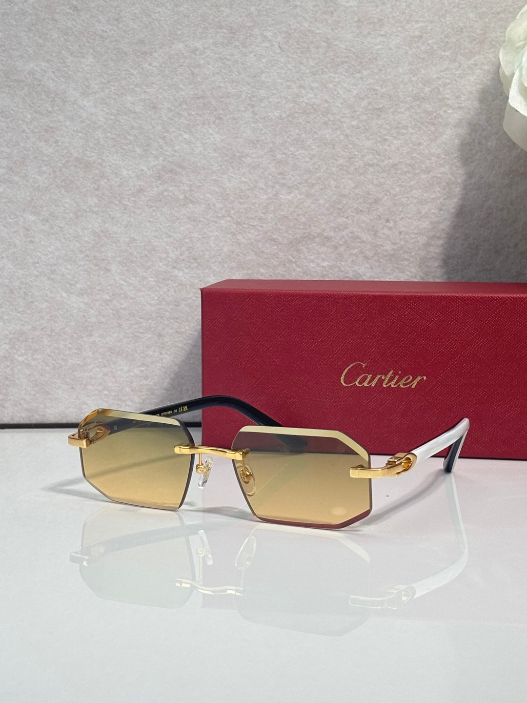 Glasses with amber-tinted rectangular lenses, gold details, and dark frame