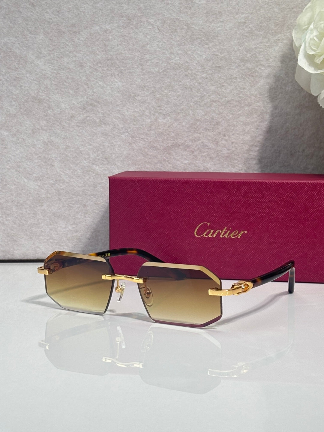 Glasses with amber gradient lenses, dark frame, and gold accents on temples