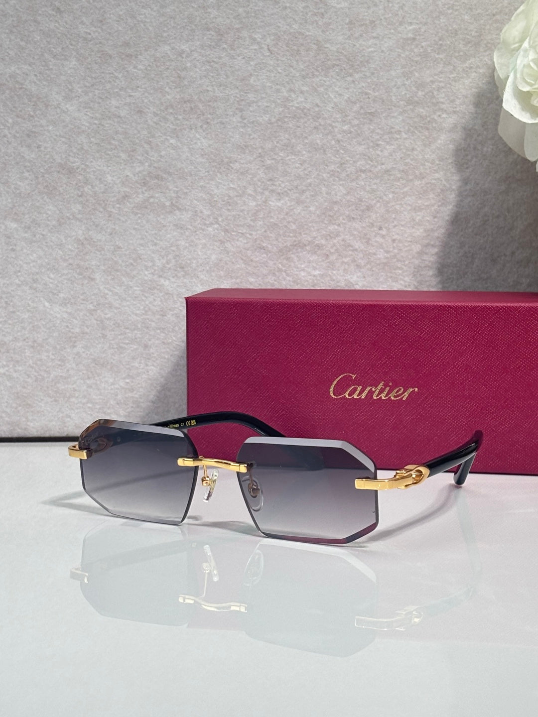 Glasses with dark frame, gold accents, and tinted rectangular lenses in profile