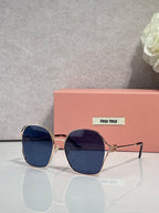 MiuMiu sunglasses, gold frames, dark blue gradient lenses with square rounded shape