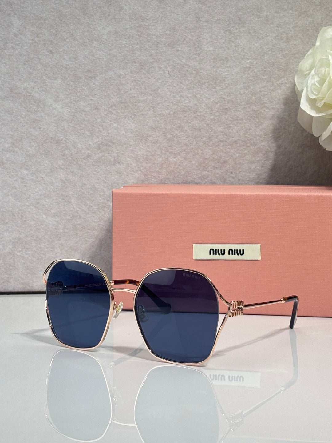 MiuMiu sunglasses, gold frames, dark blue gradient lenses with square rounded shape