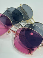 Sunglasses with purple and blue gradient lenses in gold frames