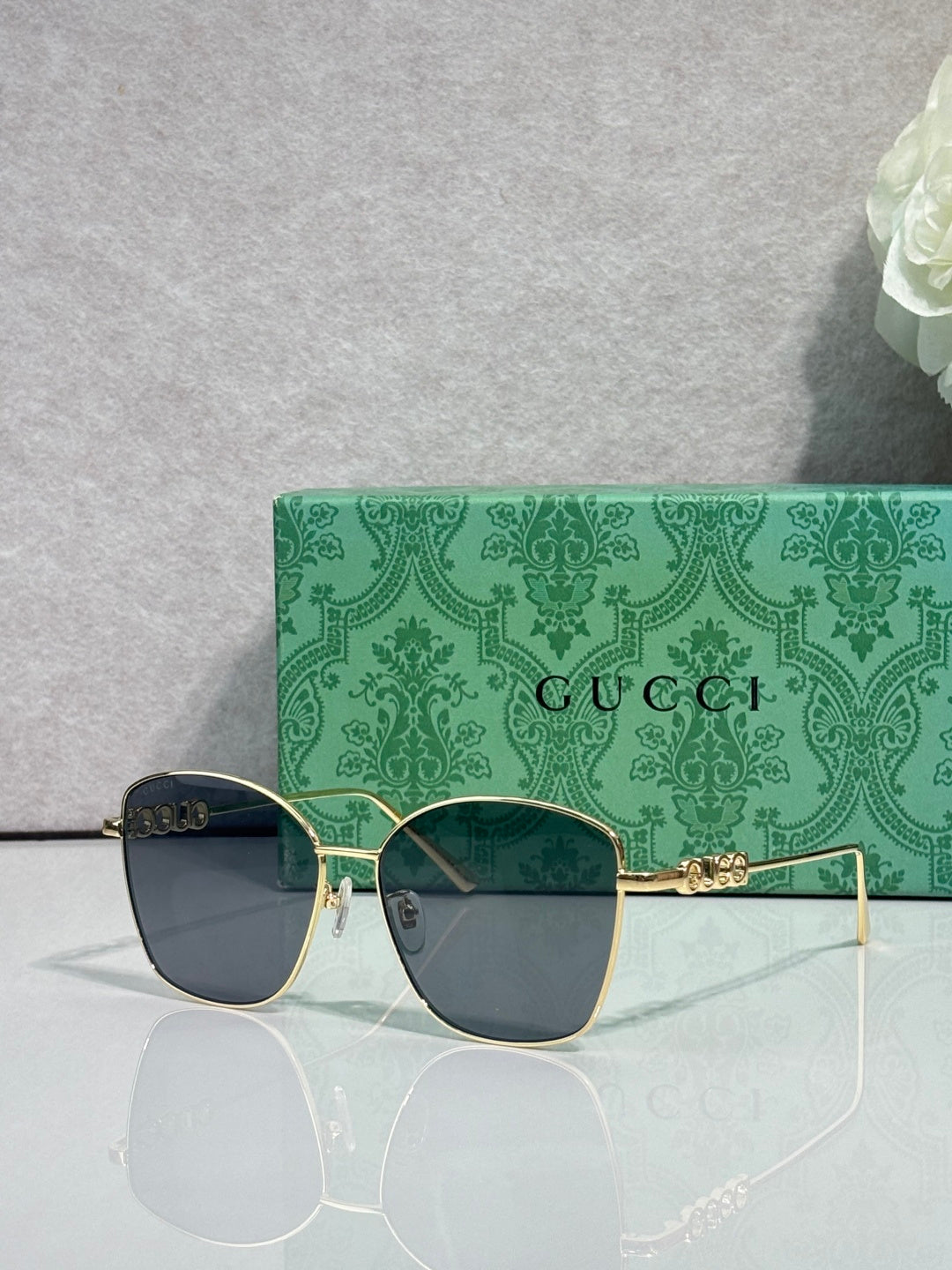 Gucci sunglasses with dark lenses and thin gold-tone arms