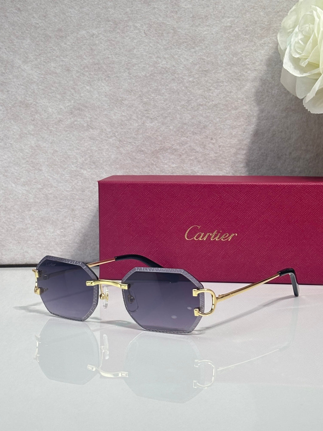 Cartier eyeglasses with gold frame and deep navy lenses, angular shield shape