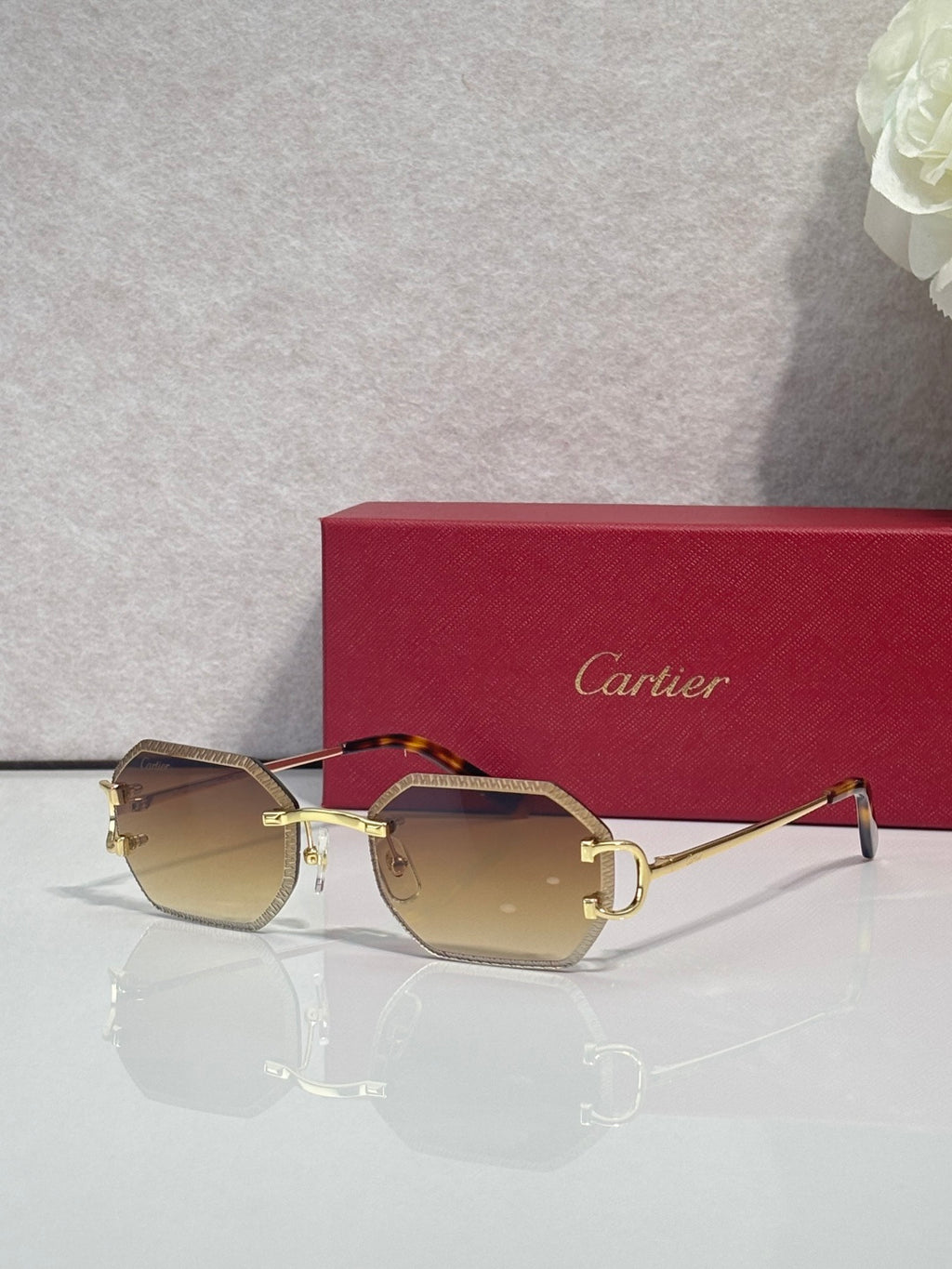 Cartier eyeglasses with gold frame and amber-tinted lenses, slim metal arms