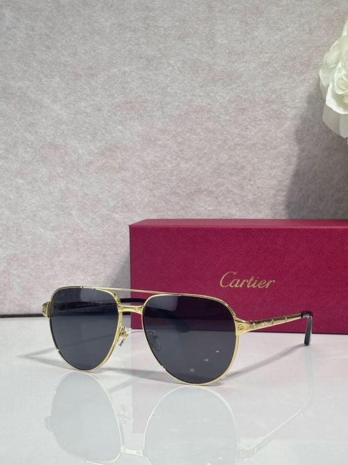 Cartier sunglasses, gold-tone metal frame with dark blue lenses, cat-eye shape