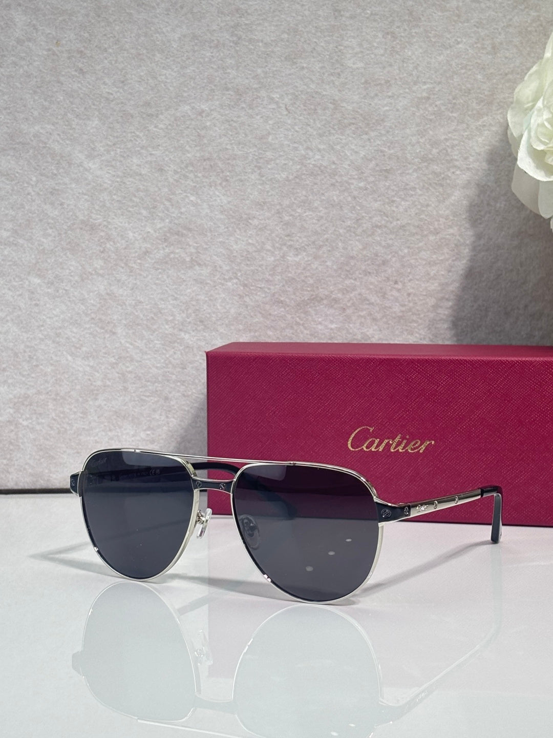 Cartier sunglasses, silver and gold frame with dark lenses, side profile
