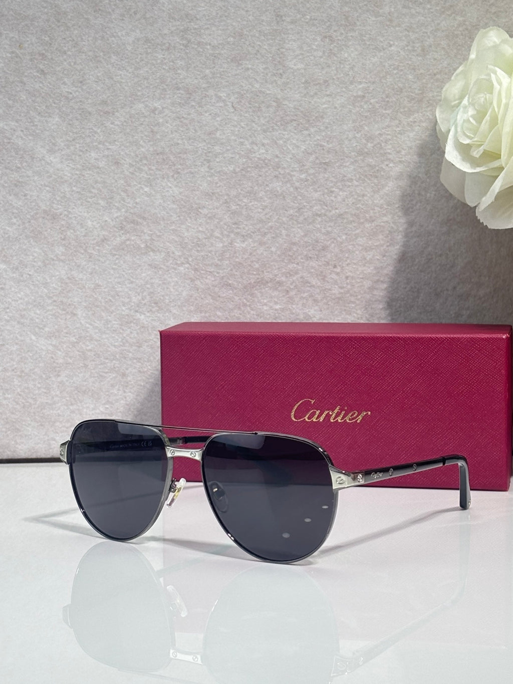 Cartier sunglasses, gold-tone frame with dark lenses, angled side view