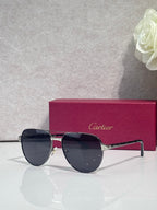 Cartier sunglasses, gold-tone frame with dark lenses, angled side view
