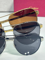 Cartier sunglasses close-up, gold temple and bridge with stacked dark lenses