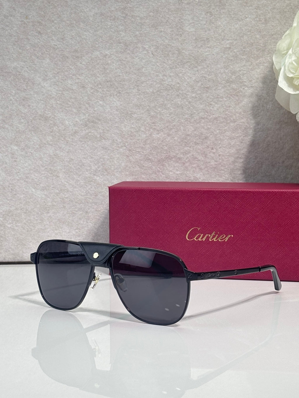 Sunglasses with dark frames and tinted lenses, angled view with metal hinge
