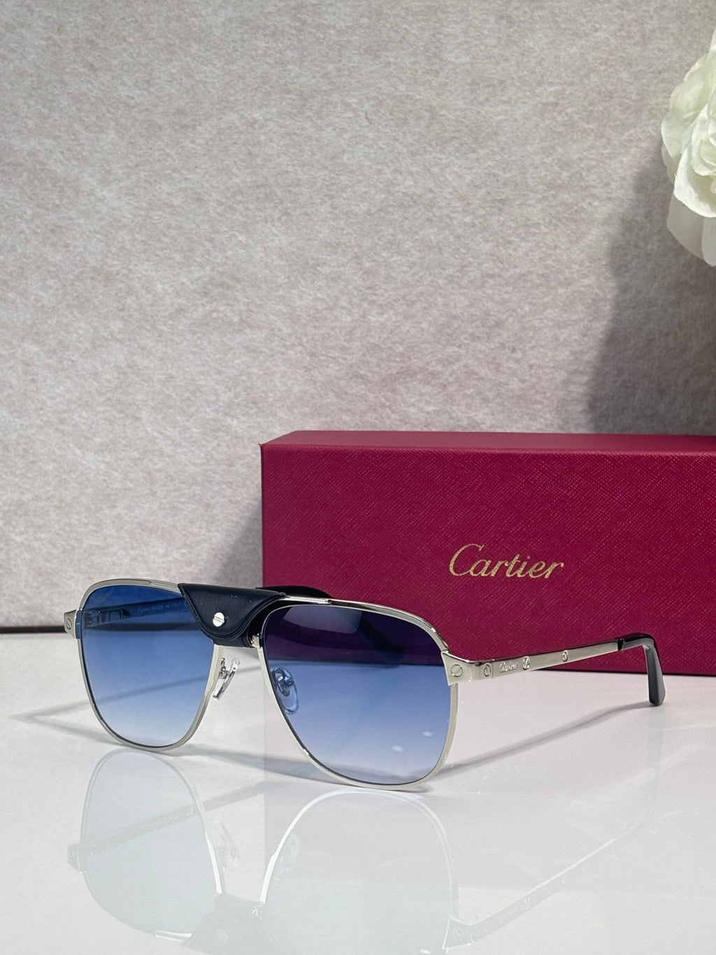 Sunglasses with dark frames and tinted lenses, metal bridge detail