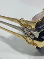 Close-up of Cartier eyeglasses: gold-tone cat head ornament and gold temple arm