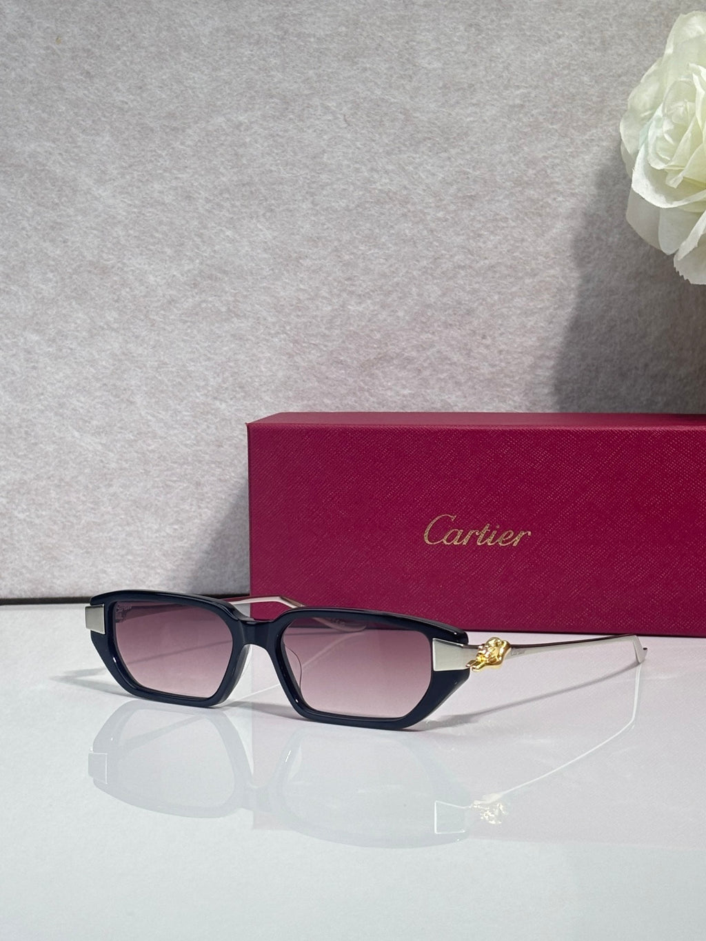 Cartier eyeglasses with dark blue frames and gold-tone cat logo detail on temple