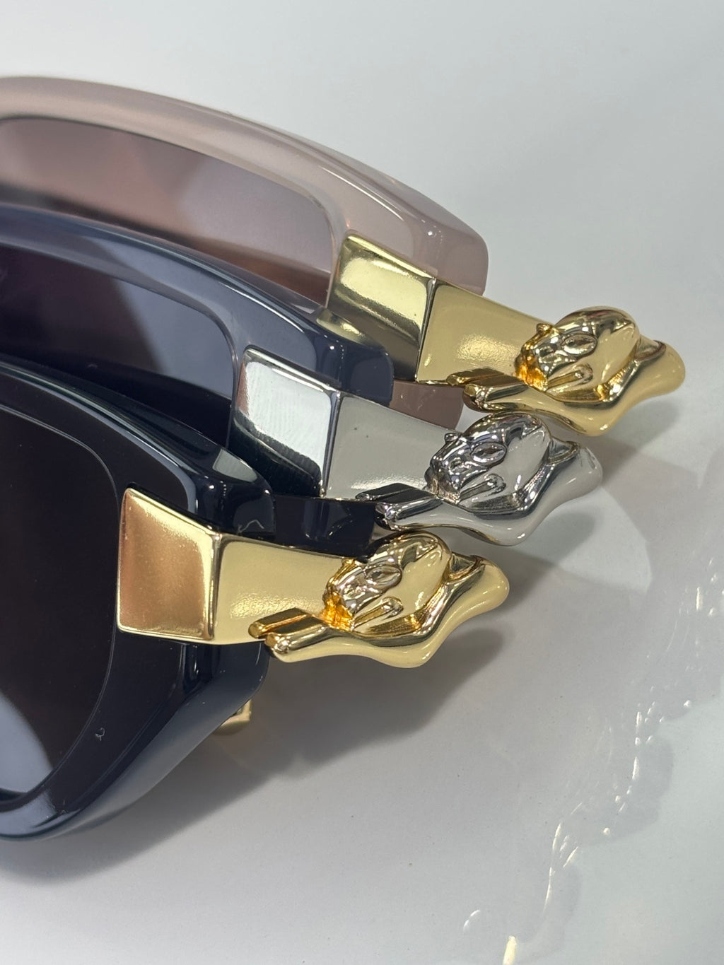 Close-up of Cartier eyeglasses temples with gold-tone cat ornament and metal hinges