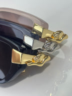 Close-up of Cartier eyeglasses temples with gold-tone cat ornament and metal hinges