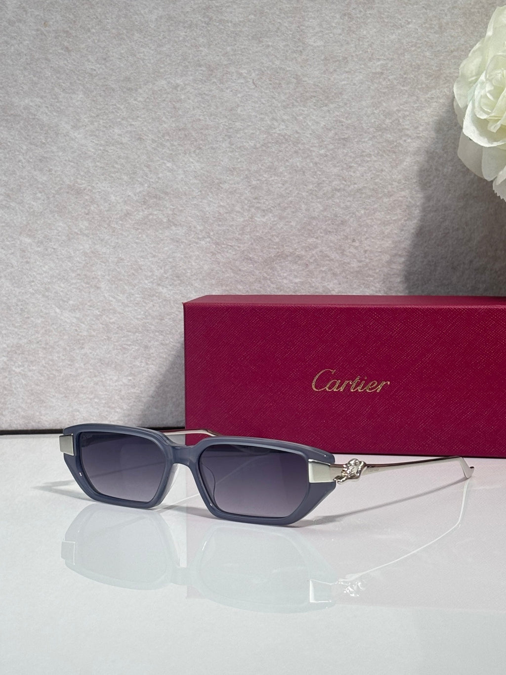 Cartier eyeglasses with dark blue frames and gold-tone cat logo arms
