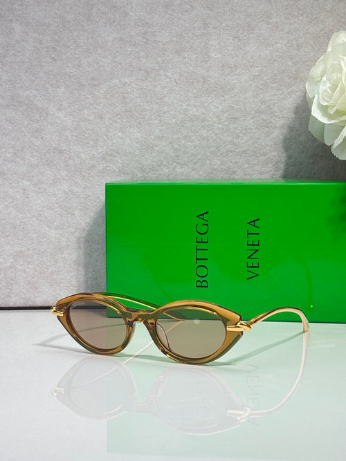 Bottega Veneta sunglasses with tortoise frames and gold-tone temples, brown lenses