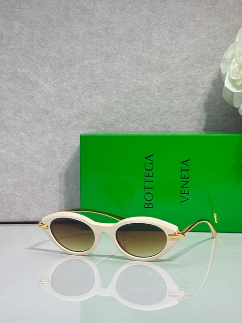 Bottega Veneta sunglasses with light frame and gold-tone temples, brown lenses