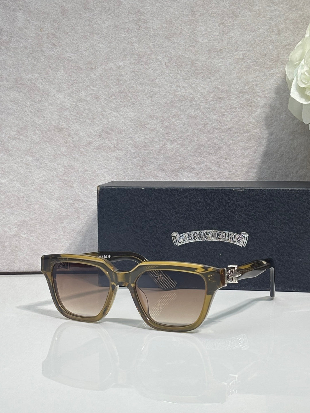 Gold and tan square sunglasses with tinted lenses and gold hinge detail