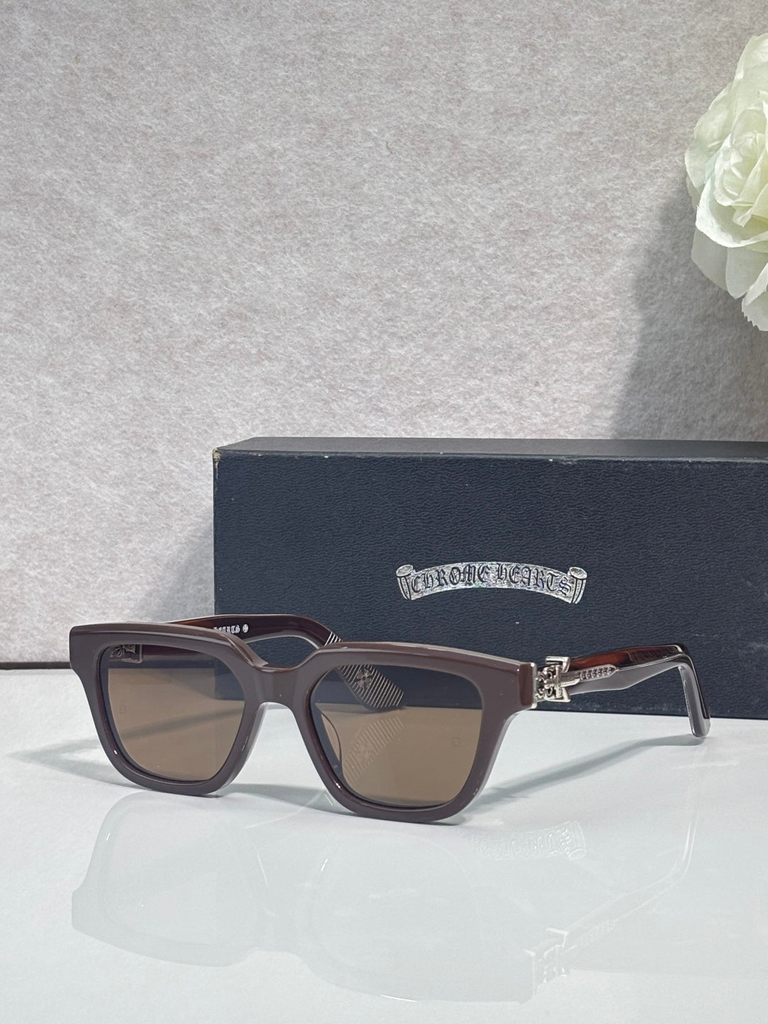 Brown square sunglasses with tinted lenses and gold hinge detail