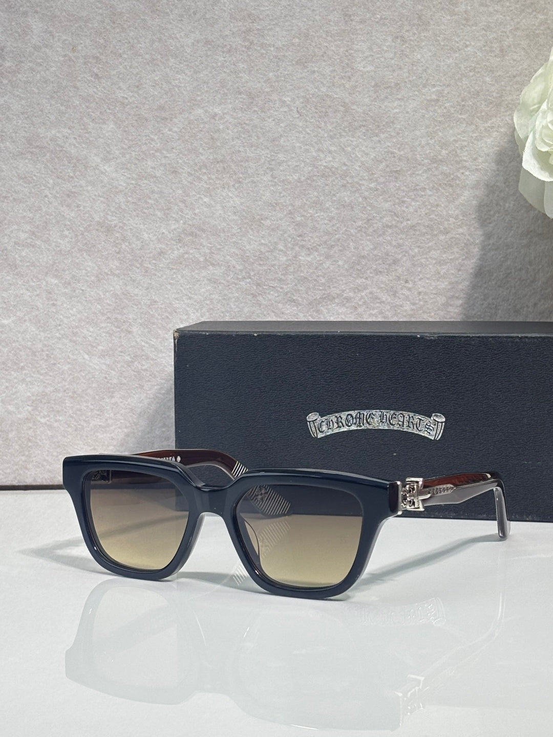 Chrome glasses with dark navy frames and clear lenses, front view