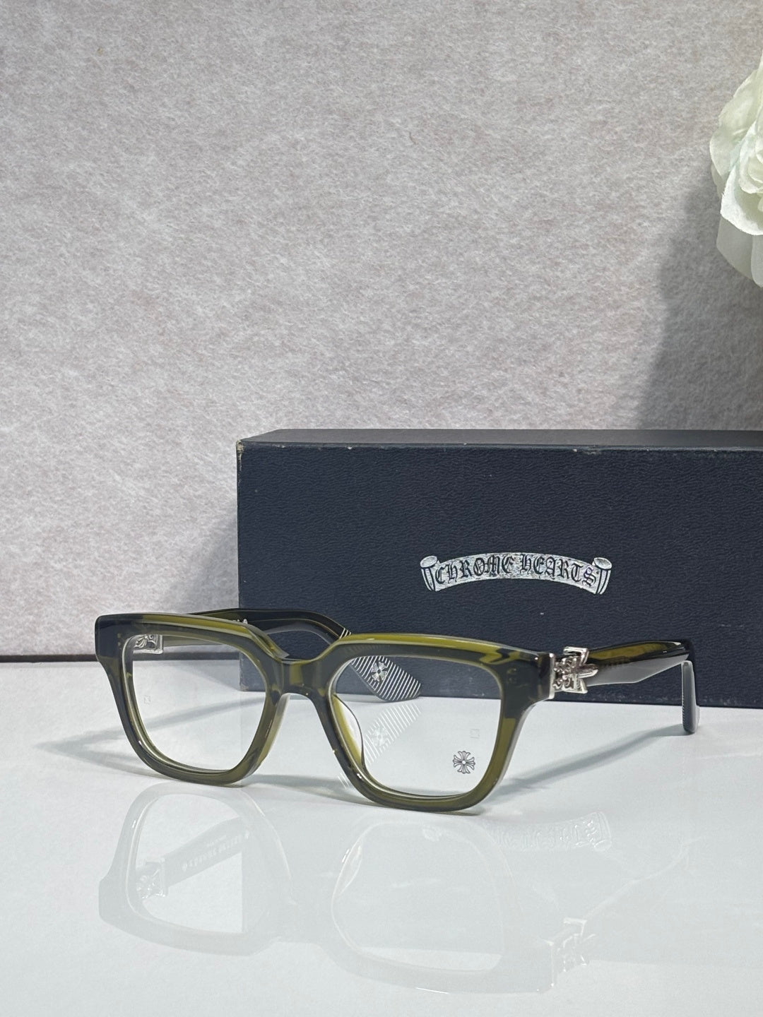 Olive green full-rim eyeglasses with clear lenses and dark side frame