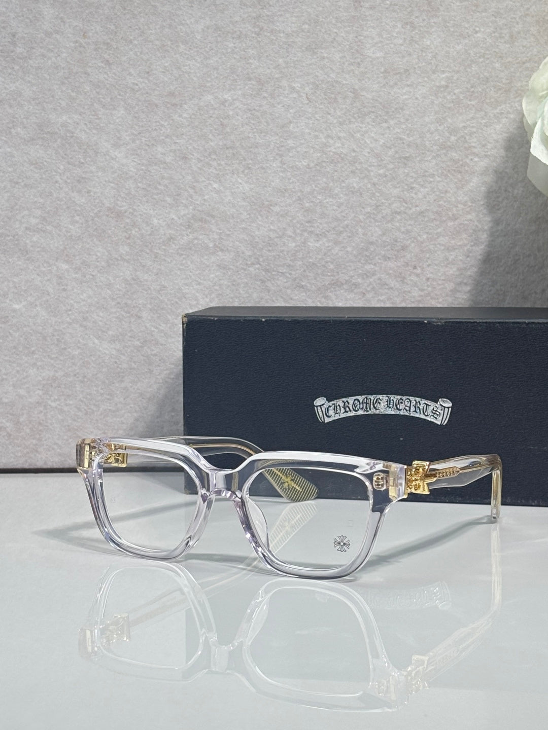 Transparent purple full-rim eyeglasses with clear lenses and ornate gold accents
