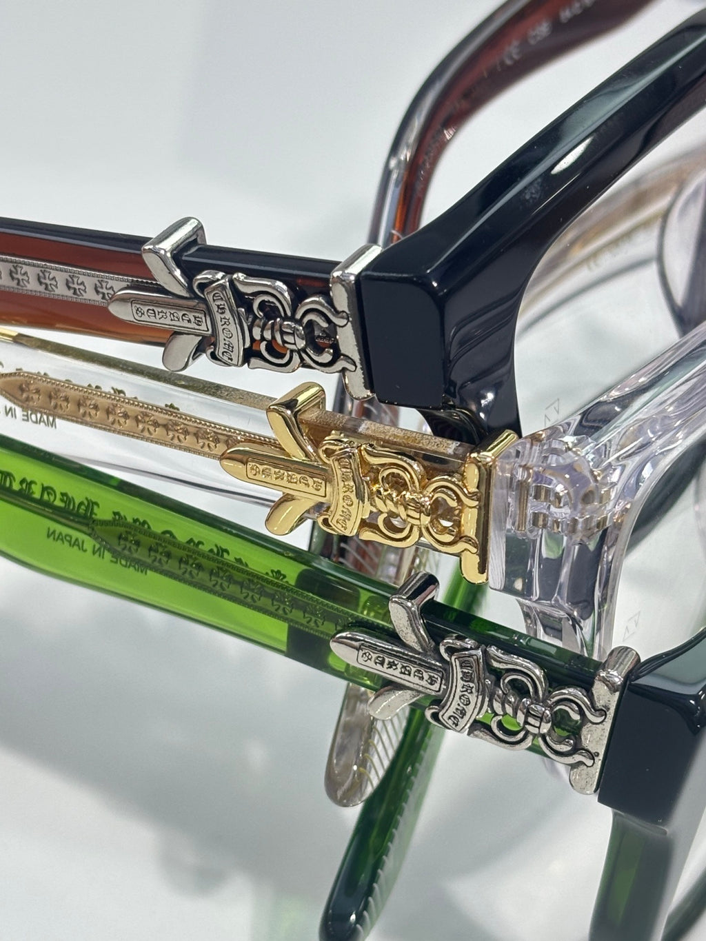 Close-up of eyeglass hinge with ornate silver and gold metal details