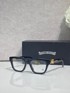 Black full-rim eyeglasses with clear lenses and gold-tone detail on the arm