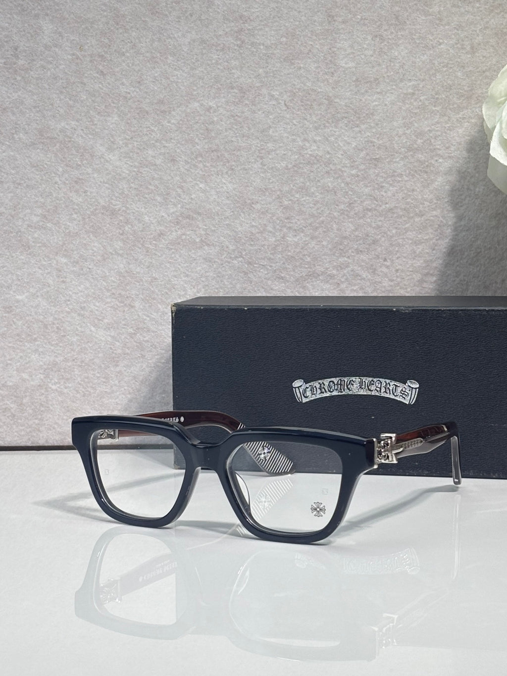 Dark blue full-rim eyeglasses with clear lenses and gold-tone hinge hardware
