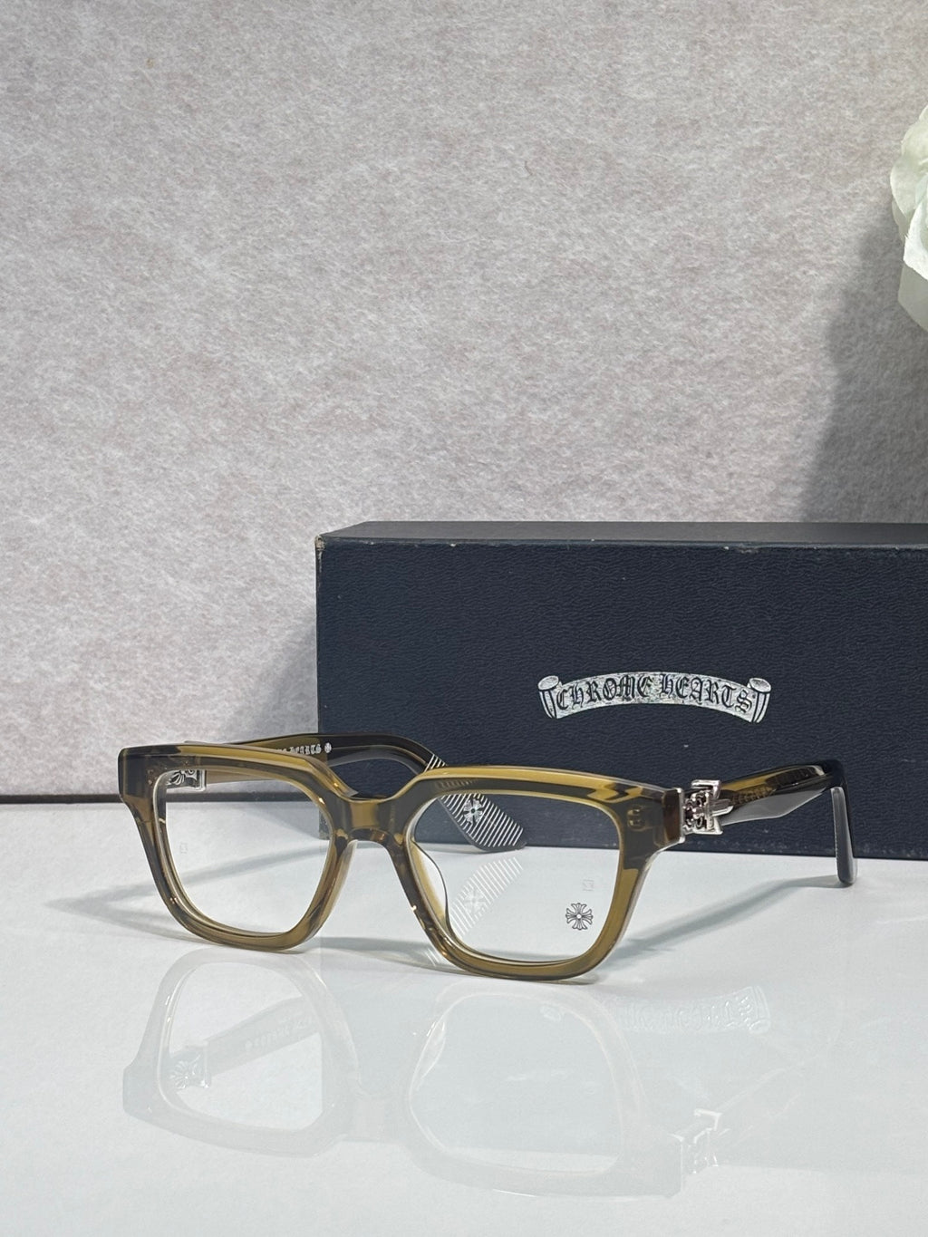 Amber and silver eyeglasses with square frames and clear lenses