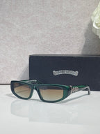 Chrome glasses with teal frames and neutral-tinted lenses, with star-shaped metal accents.