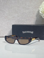 Chrome glasses with tortoiseshell frames, brown-tinted lenses, and gold star details on temples.