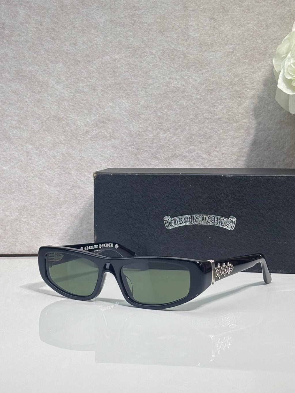 Chrome glasses with dark blue frames and green-tinted lenses, featuring star metal accents.