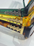 Chrome glasses close-up of hinged temple with gold and star embellishments and colored frame.