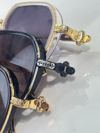 Sunglasses hinge close-up with gold-tone metal and jeweled bar detail