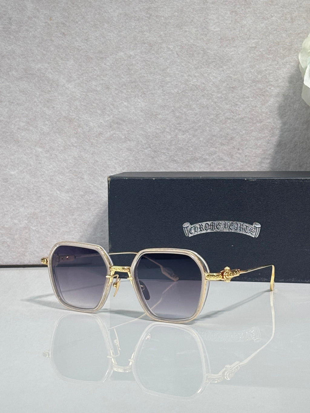 Gold-rim square sunglasses with dark lenses and muted brown frame accents