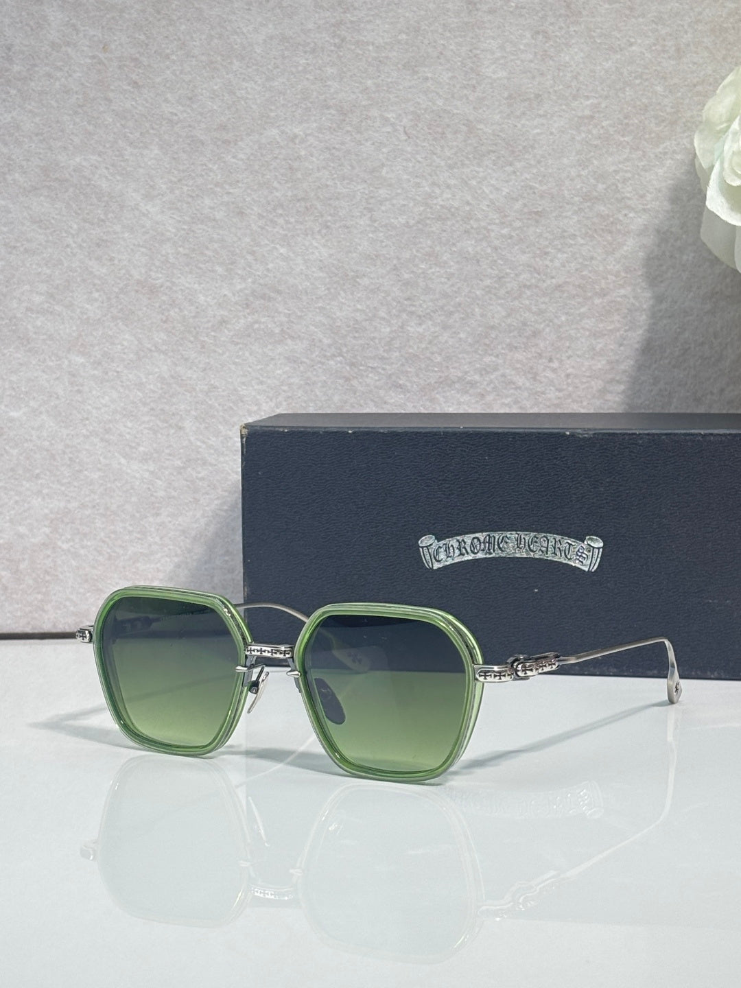 Chrome-rim square sunglasses, dark lenses and green frame with gold-tone hinge detail
